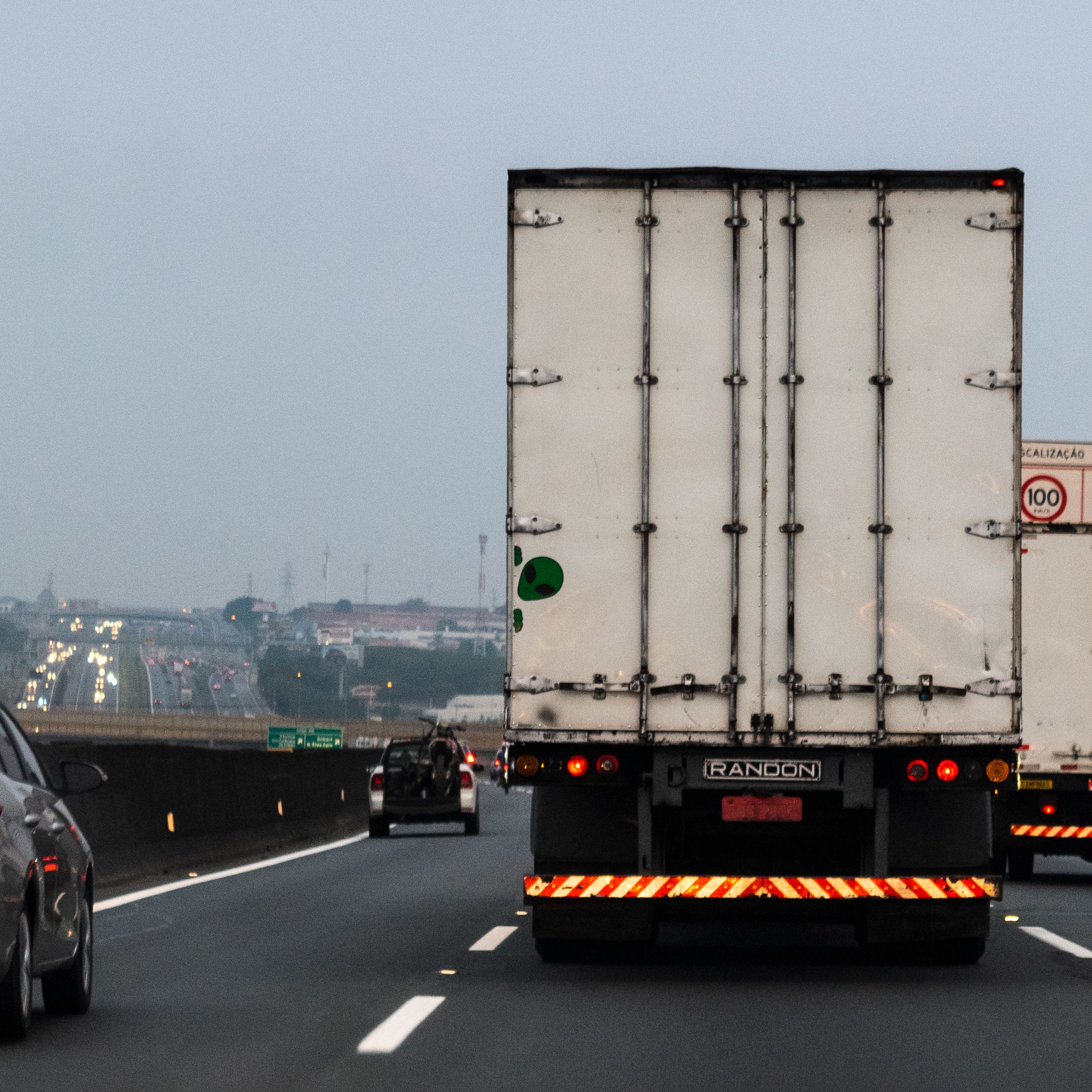 Rear view of a truck on a foggy highway in Sumaré, Brazil, showcasing logistics transportation.